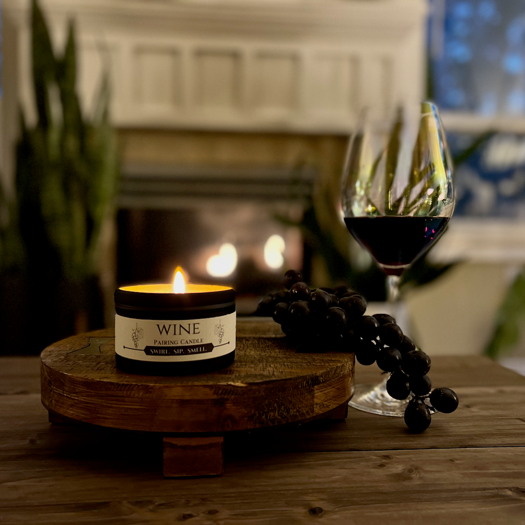 Wine Pairing with grapes and glass of red wine by the fireplace